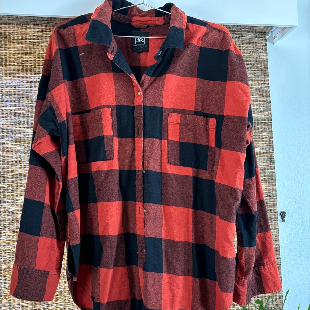 Rip curl flannel . Orange and black . Good condition.